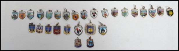 A collection of continental silver armorial shield enamel crest charms each stamped 800. Largest