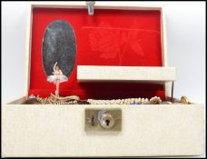 A vintage jewellery box full of vintage 20th century costume dress jewellery to include necklaces,