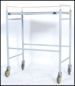 An original mid century Industrial surgeons theatre trolley of tubular metal and stainless steel