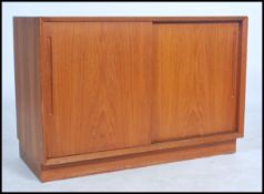 A good Danish 1960's teak wood sideboard cabinet raised on an inset plinth base with twin sliding