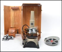 A 20th century cased electronic microscope with three objectives complete in the wooden carry case
