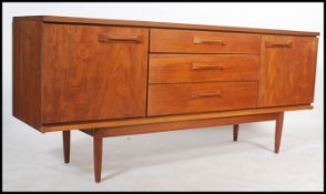 A vintage 20th century teak wood Danish influence sideboard, having a bank of three central