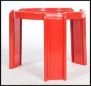 A vintage mid 20th century retro Kartell red plastic table, designed by Giotto Stoppino, circular on