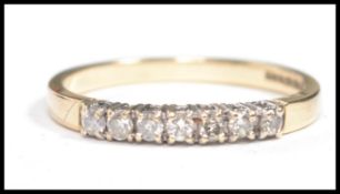 A hallmarked 9ct gold diamond set ring having seven diamonds in a white gold setting, hallmarked for