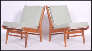 A fantastic pair of low Scandart armless easy chairs in stained beech having angular form. The