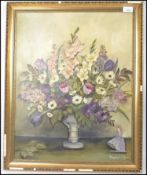 A 20th century framed oil on canvas still life study painting, the painting depicting a vase of