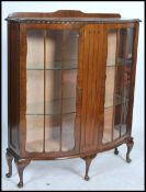 An Edwardian oak twin door display cabinet, fitted