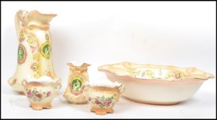 An Edwardian 4 piece washbowl and jug set in an ivory blush pattern having maiden cartouche panels