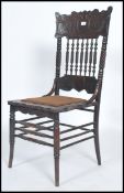 An early 20th century carved oak American hall chair with spiral twist supports and back rest with