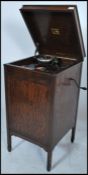 An early 20th century oak His Masters Voice floorstanding gramaphone cabinet raised on squared