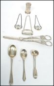 A good group of silver items to include a hallmarked silver pepperette, silver wine label, a pair of