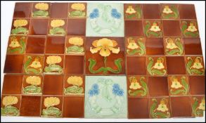 A group of fifteen 19th century majolica tiles being tube lined in the Art Nouveau style. Highest