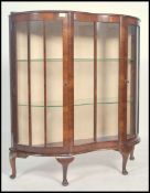 A 20th century Art Deco Walnut veneered serpentine glass fronted display cabinet fitted with two