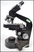 A vintage 20th century Swiss made Wild Heerburgg M20 Microscope, with four objectives. Measures 38