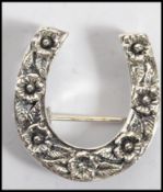 A good silver and marcasite adorned ladies lucky horse brooch having floral decoration. Weight 5.5g.