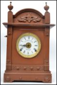 A late 19th century Aesthetic movement oak cased mantel clock, white enamel dial signed 'Fattorini &