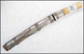 A silver asiatic dagger with bone handle. Silver foil covered scabbard with bone handled knife.