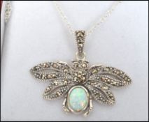 A contemporary ladies silver marcasite and opal pendant necklace in the form of a butterfly and