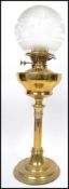 An early 20th century brass and frosted glass oil lamp in the neo classical style. The brass