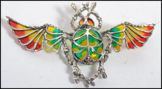 A large silver shaped plique a jour brooch in the form of a flying scarab beetle. Total weight 11.