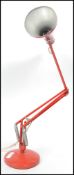 A vintage 20th century retro Herbert Terry 90 anglepoise desk lamp in red with circular base and