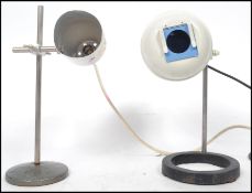 Two vintage 20th century retro industrial laboratory lamps one being a Philip Harris raised on