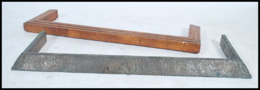 A vintage 20th century Arts and Crafts / Art Nouveau copper hand beaten fire fender together with