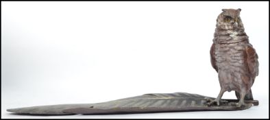 An impressive and unusual cold painted bronze owl on feather inkwell being signed to the base.