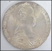 An Austrian 1780 silver Maria Theresa Thaler coin, weighs 28 grams. Measures 4 cm diameter.