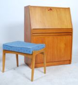 A retro 20th century teak wood bureau with fall front having a fully appointed interior over