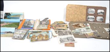 A collection of vintage postcards and photograph albums dating from the early 20th century with