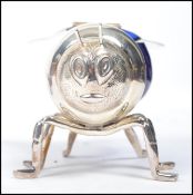 A silver plated and blue glass honey pot in the form of a bee having chased decorated hinged wings