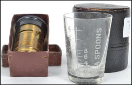 A vintage 20th century field brass miniature microscope in box along with a boxed scientific