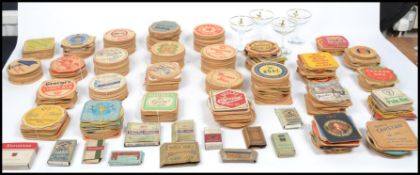 A large collection of vintage beer mats dating from the 1960s to include beers from around the world