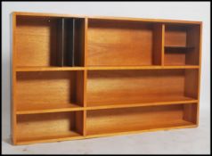 A retro 20th century pine hanging bookshelf unit having varying sized section, unusual