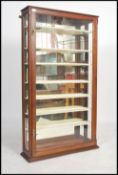 A 19th century Victorian mahogany shop display cabinet of thin upright form having mirror lined