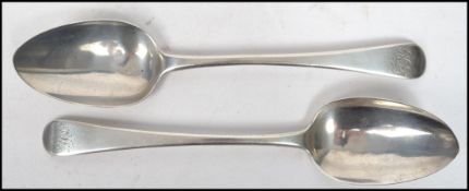 A pair of early 19th century Georgian silver hallmarked table spoons of plain form having