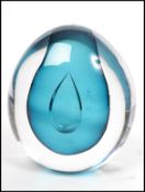 A vintage 20th century studio art glass paperweight of spherical form having a central clear