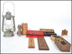 A collection of curios to include boxed dominoes, cribbage boards, a box wood chess set, oil lamp