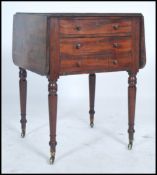 A 19th century mahogany ladies work box table being raised on turned legs with brass castors