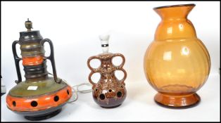 A 1970's Fat Lava drip glaze table lamp together with another similar both marked West German