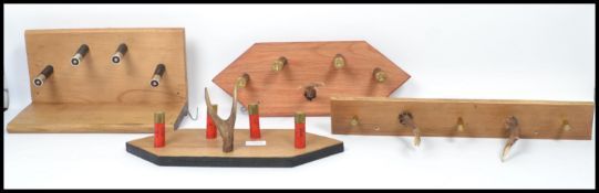An unusual group of vintage taxidermy hunting interest antler and shot gun shell coat racks