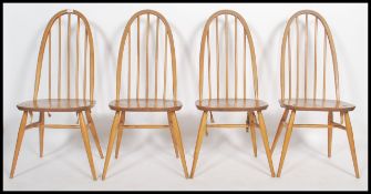 A set of four Ercol light coloured beech and elm framed Windsor, high hoop, spindled back dining