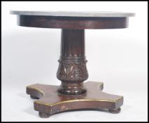 A 19th century French mahogany and gilt painted centre table / dining table having tripod base