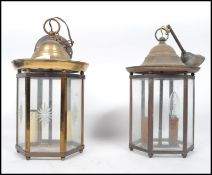 A pair of 20th century brass porch lanterns, each of hexagonal form with frosted and clear glass