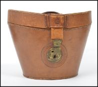 A late 19th century Victorian tan brown leather top hat box with lined interior, straps to the outer