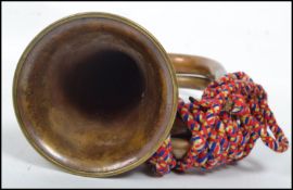 A vintage 20th century military brass copper and white metal bugle complete with mouthpiece and