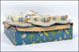 An early 20th century Childrens lustre tea service set complete in the original box to include the