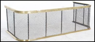A 19th century Georgian brass railed nursery fire fender of bowed form having a pierced mesh