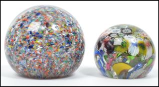Two vintage 20th century studio art glass paperweight one having millefiori canes with aventurine